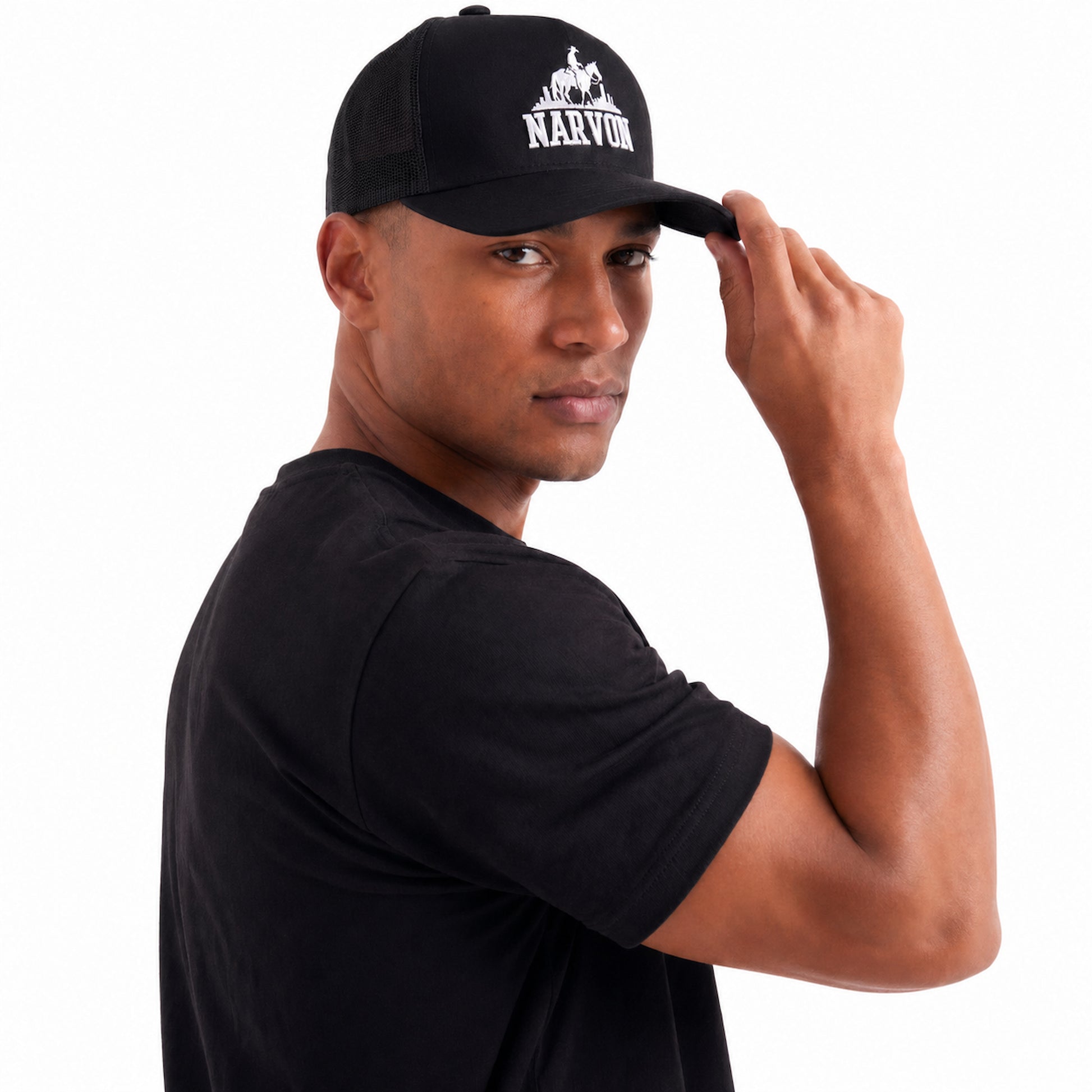 Mens black trucker hat with adjustable snapback and curved brim worn in casual outfit