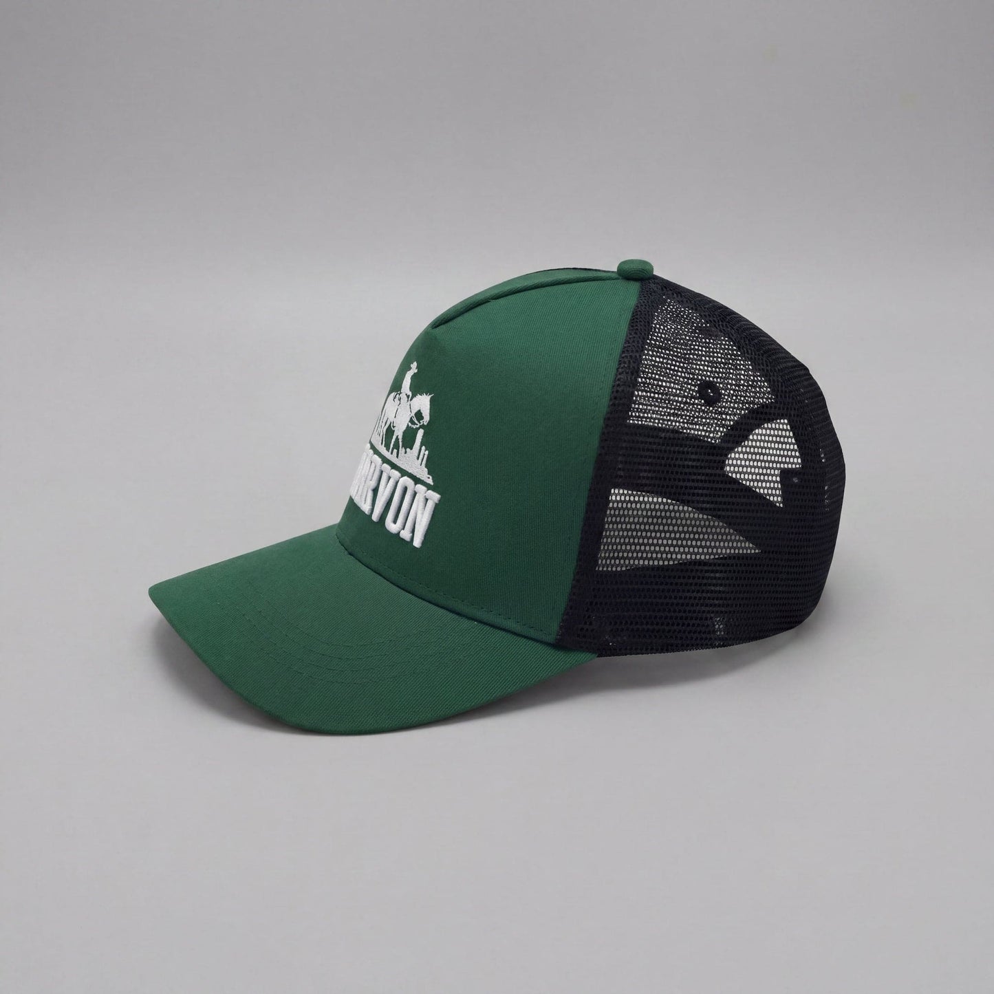 Side profile of men’s green trucker cap with black mesh back and structured front panel