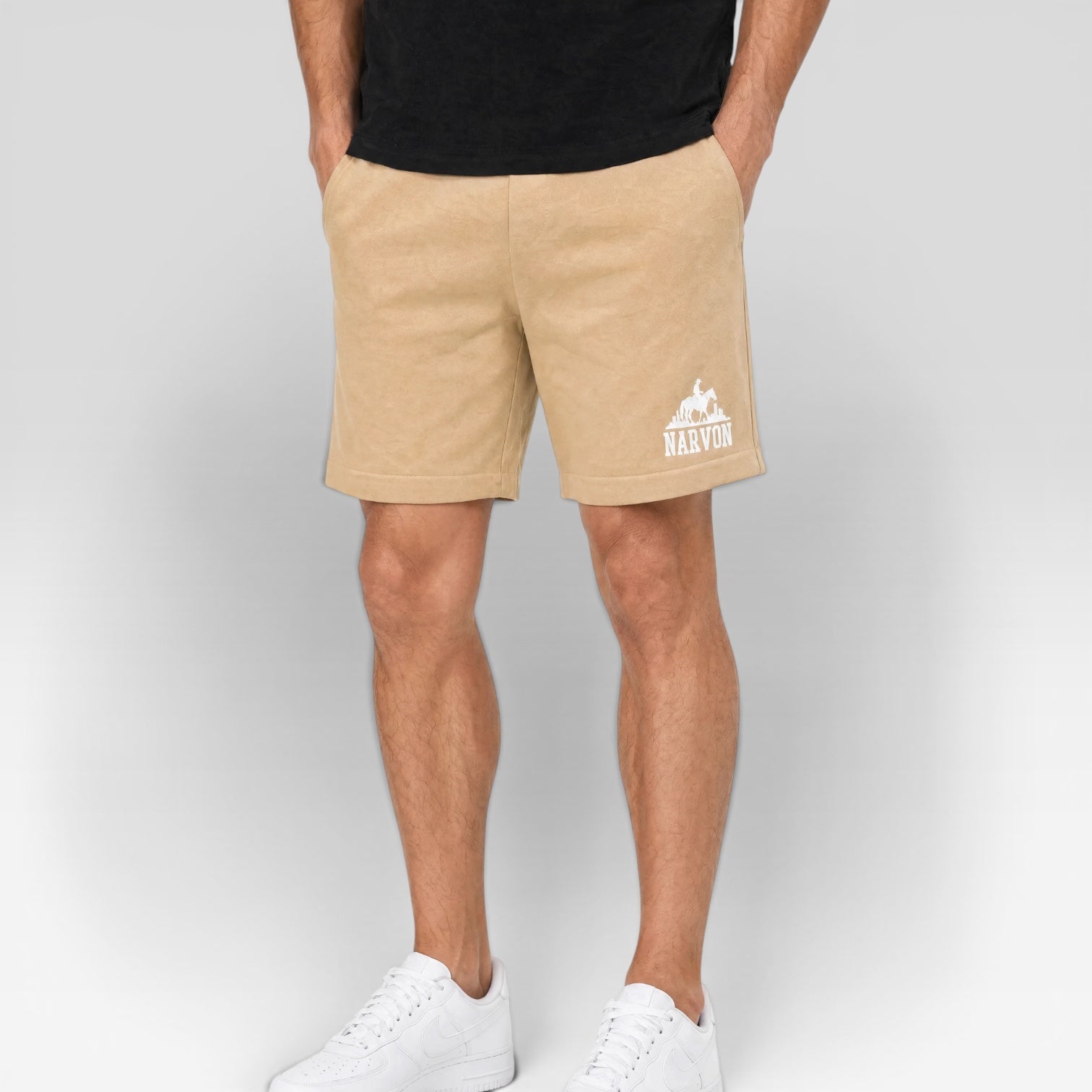 Men wearing beige casual shorts with relaxed fit styled in a clean summer outfit with sneakers