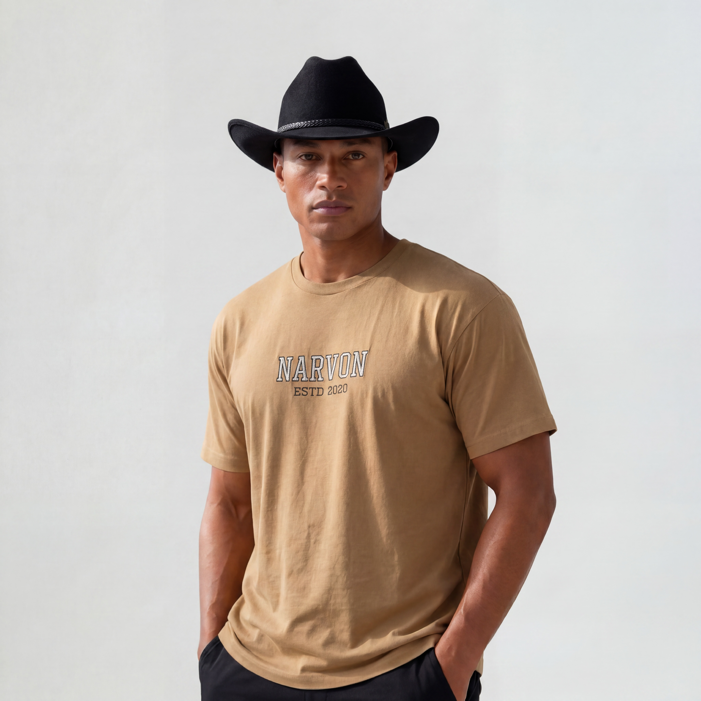 Men’s tan cotton t-shirt with relaxed fit styled with cowboy hat for a modern western look