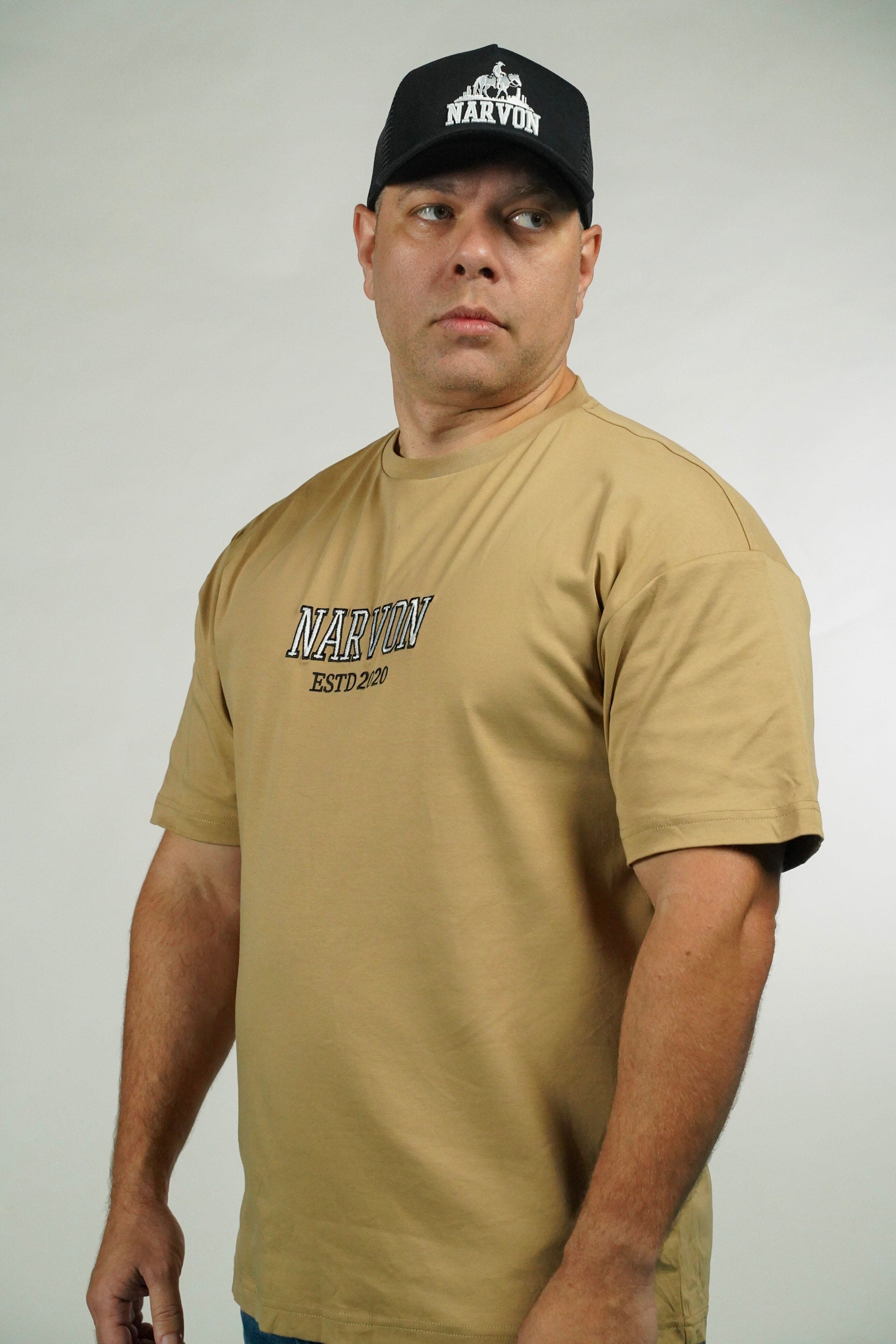 Man wearing a tan t-shirt with 'Narvon' branding and a black cap with 'Narvon' logo on a white background