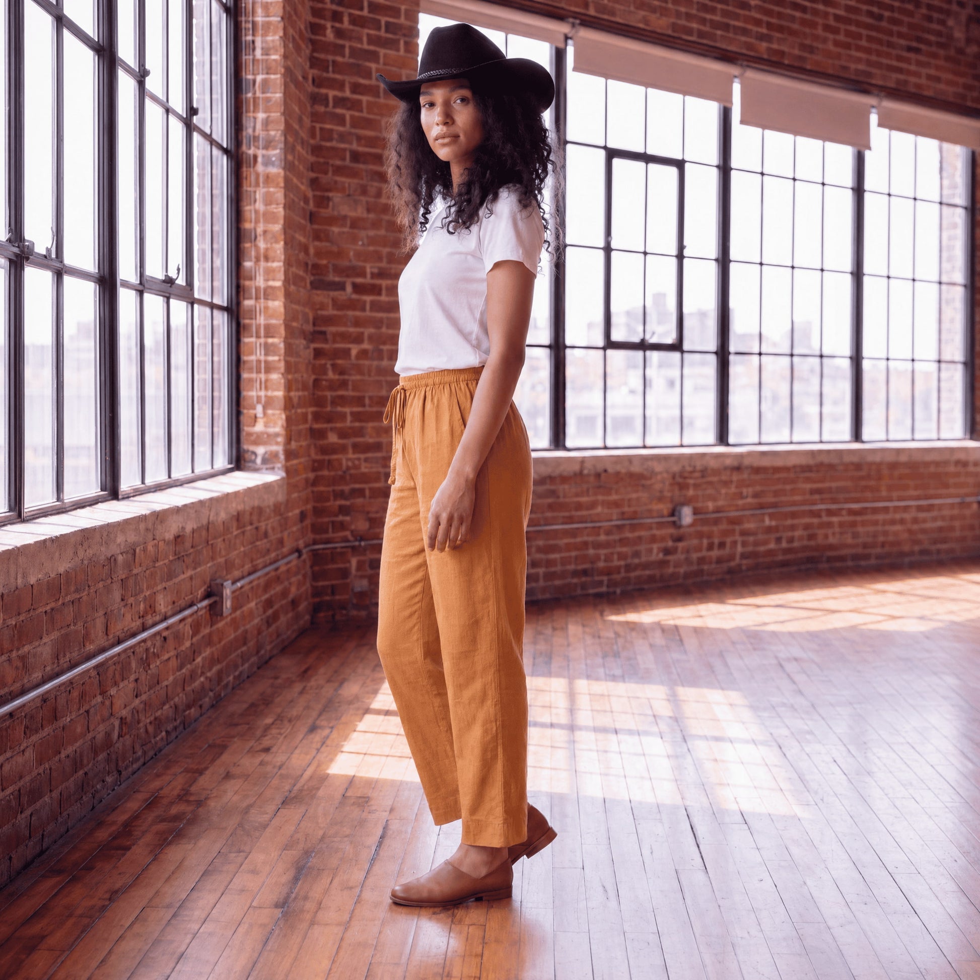 Side view of women’s brown linen pants with wide leg and relaxed fit